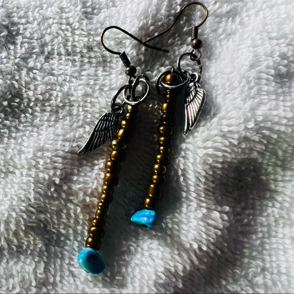 Earrings handmade beadwork with silver feather